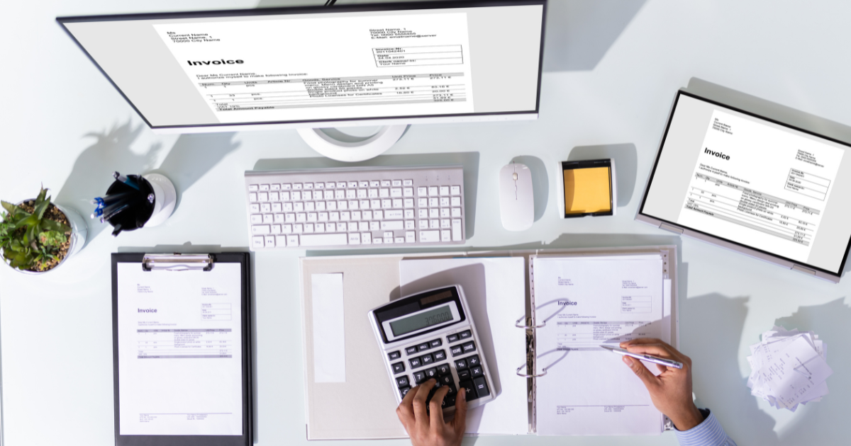 What Landlords Need to Know About Making Tax Digital in 2026 Making Tax Digital - an image of someone doing their tax calculations over invoices on a computer