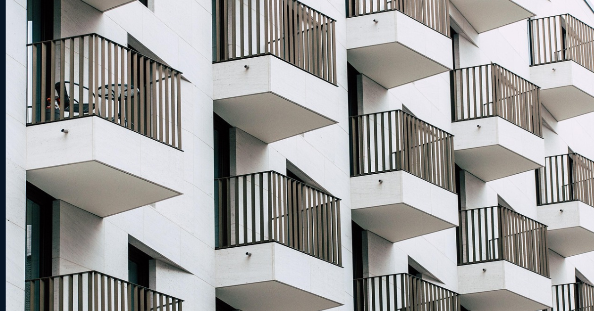 Why Your Neighbour’s Property Outperforms Yours Neighbour's property from outdoors, white building and black balconies with modern design.