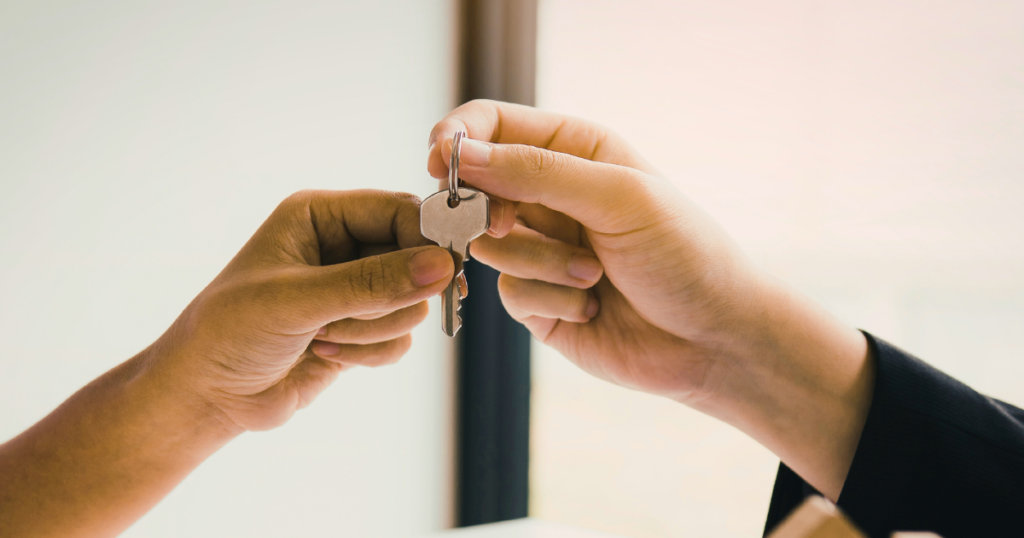 someone handing over keys - hands only. switching property manager